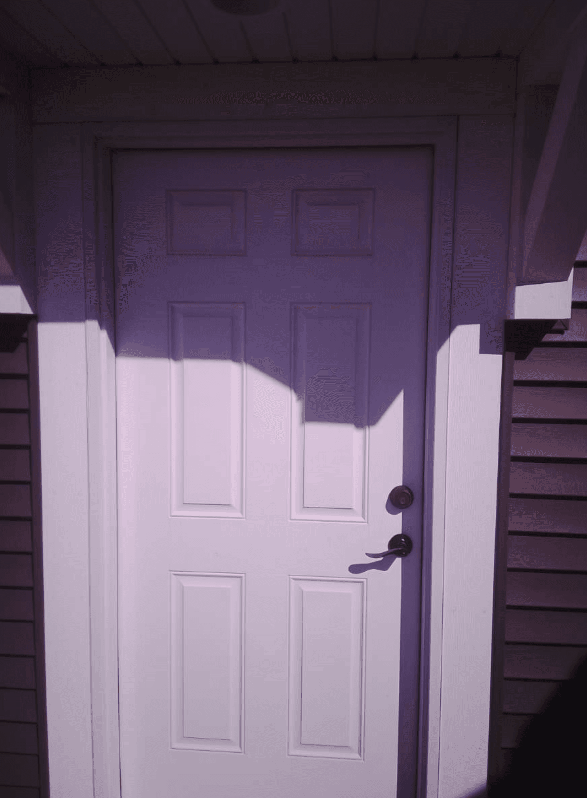 Inspector examining exterior door during a pre-listing inspection